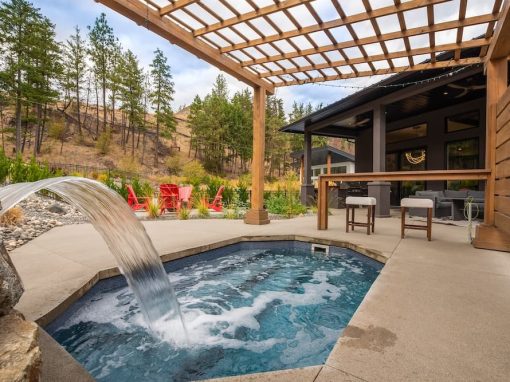 Long backyard jacuzzi with waterfall and bar